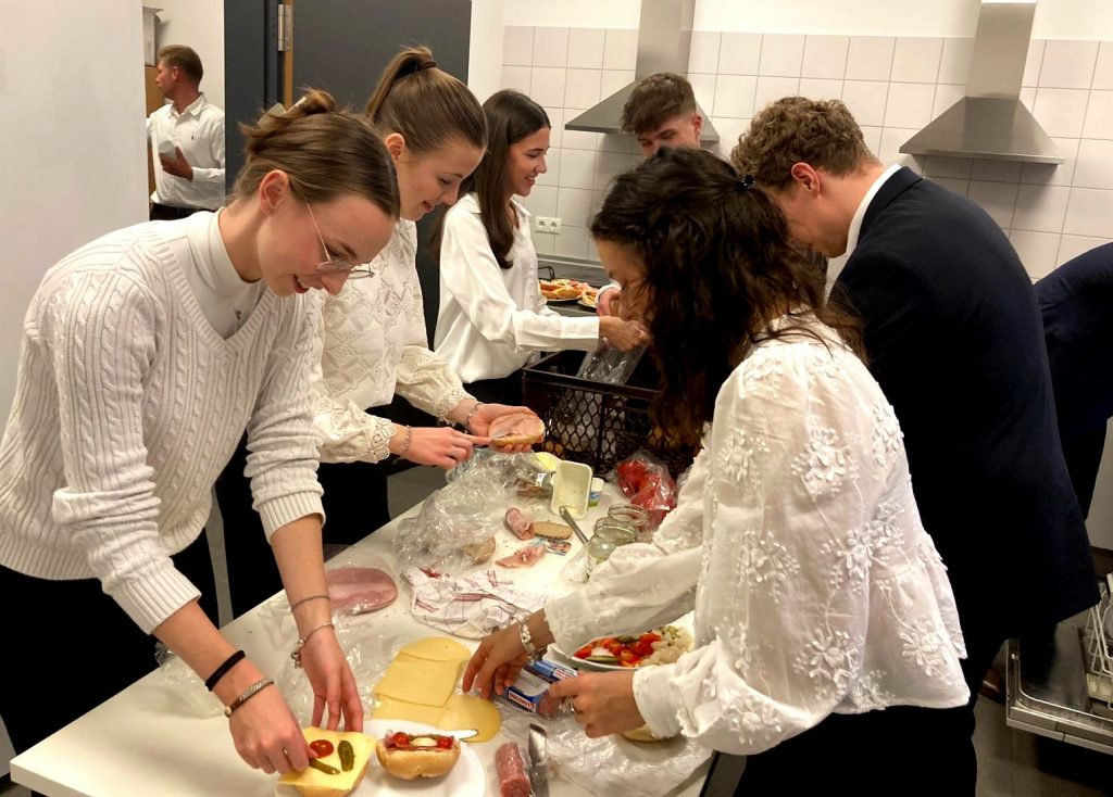 Die fleißigen Junggesellinnen und Junggesellen beim Brötchenschmieren für das Abendessen (Foto: Bianca Zepp)